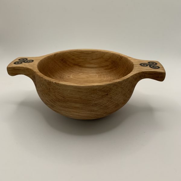 A beautiful wooden quaich handcrafted from locally sourced Scottish oak and engraved with a triskele design