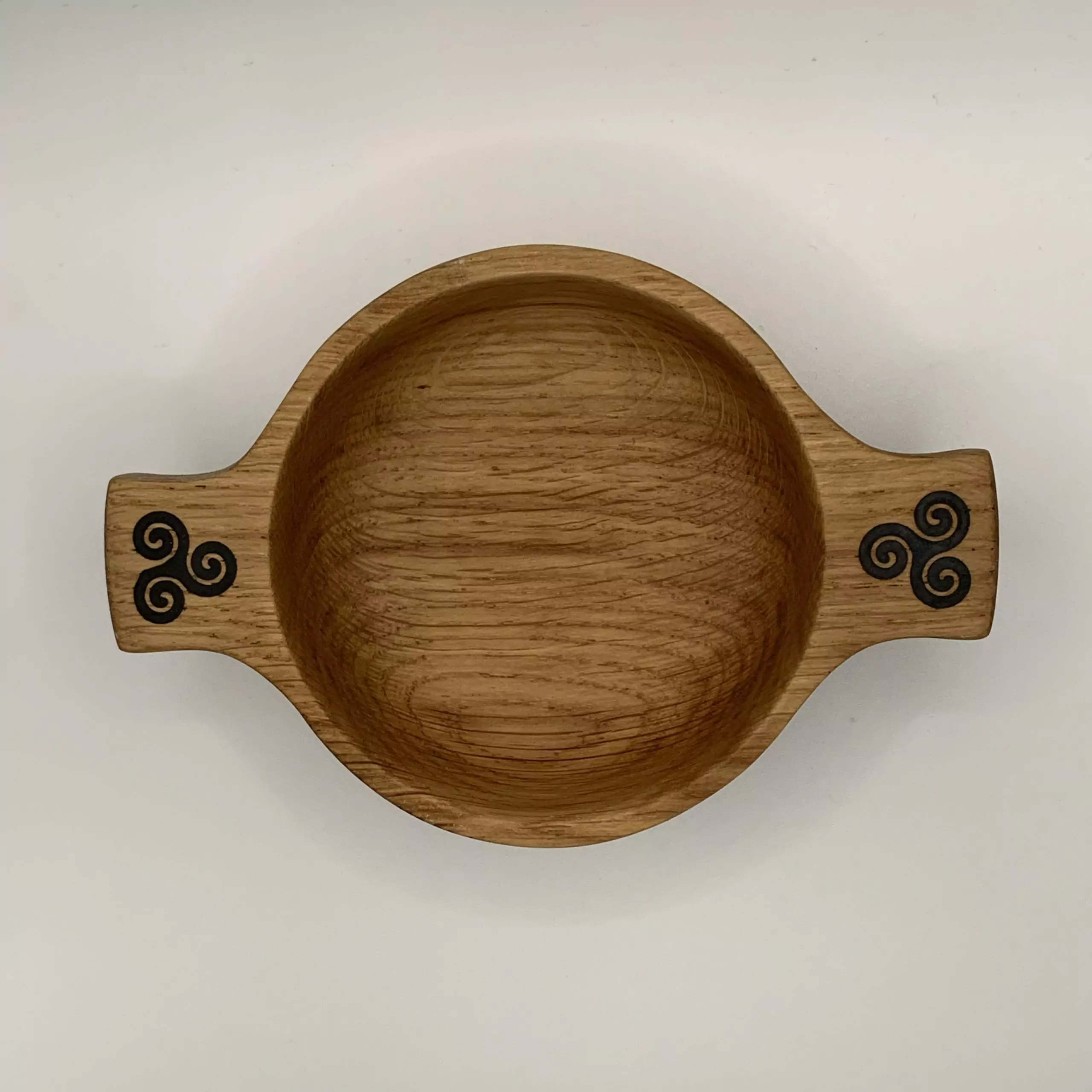 A beautiful wooden quaich handcrafted from locally sourced Scottish oak and engraved with a triskele design