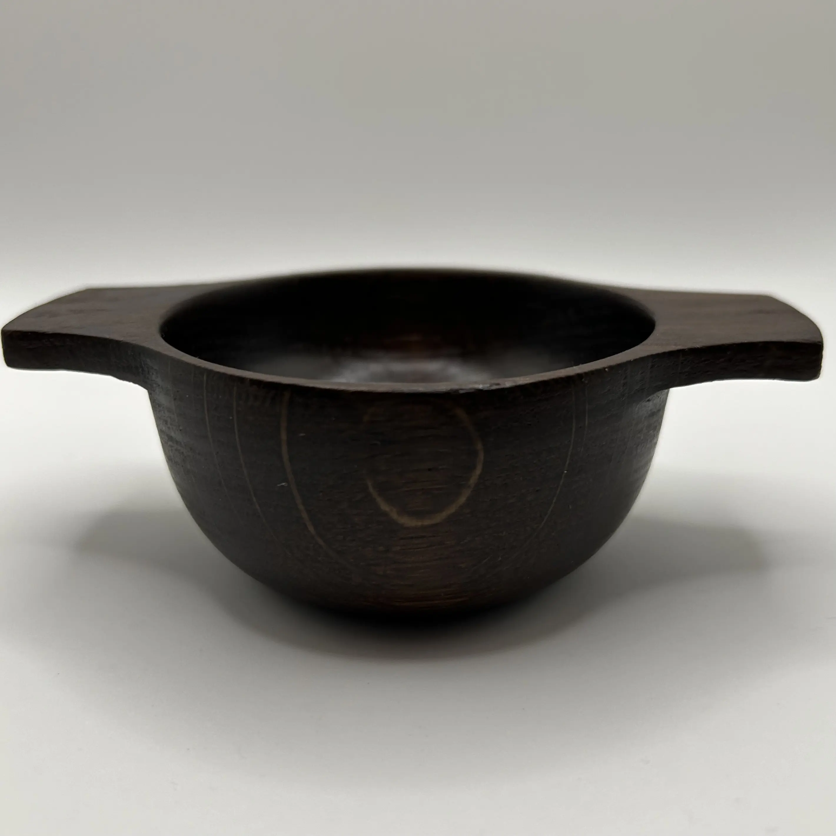 A hand turned oak fumed quaich