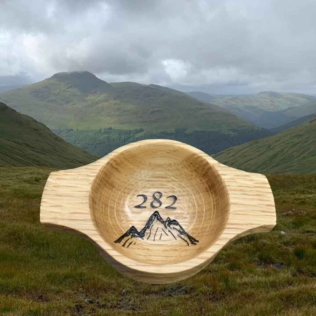 A handcrafted wooden oak quaich engraved with a mountain design and 282 to commemorate the completion and successful ascent of all Scottish munro
