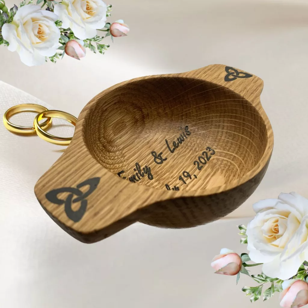 A unique handcrafted wooden oak wedding quaich engraved with names and dates of the happy couple