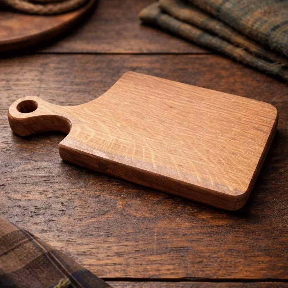 Small chopping board handmade from reclaimed Scottish whisky barrel lid